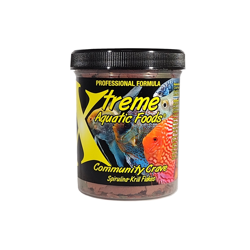 A clear container of Xtreme 28g Community Crave Flake fish food, showing the product name and description, alongside a label showing various fish.
