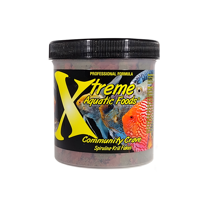 A clear container of Xtreme 56g Community Crave Flake fish food, showing the product name and description, alongside a label showing various fish.